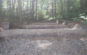 lonely steps carved into a hill with gravel and debris covering over.